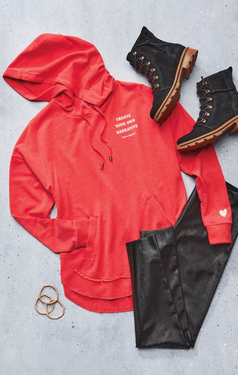 Lay down of red sweatshirt, faux leather leggings, and black boots