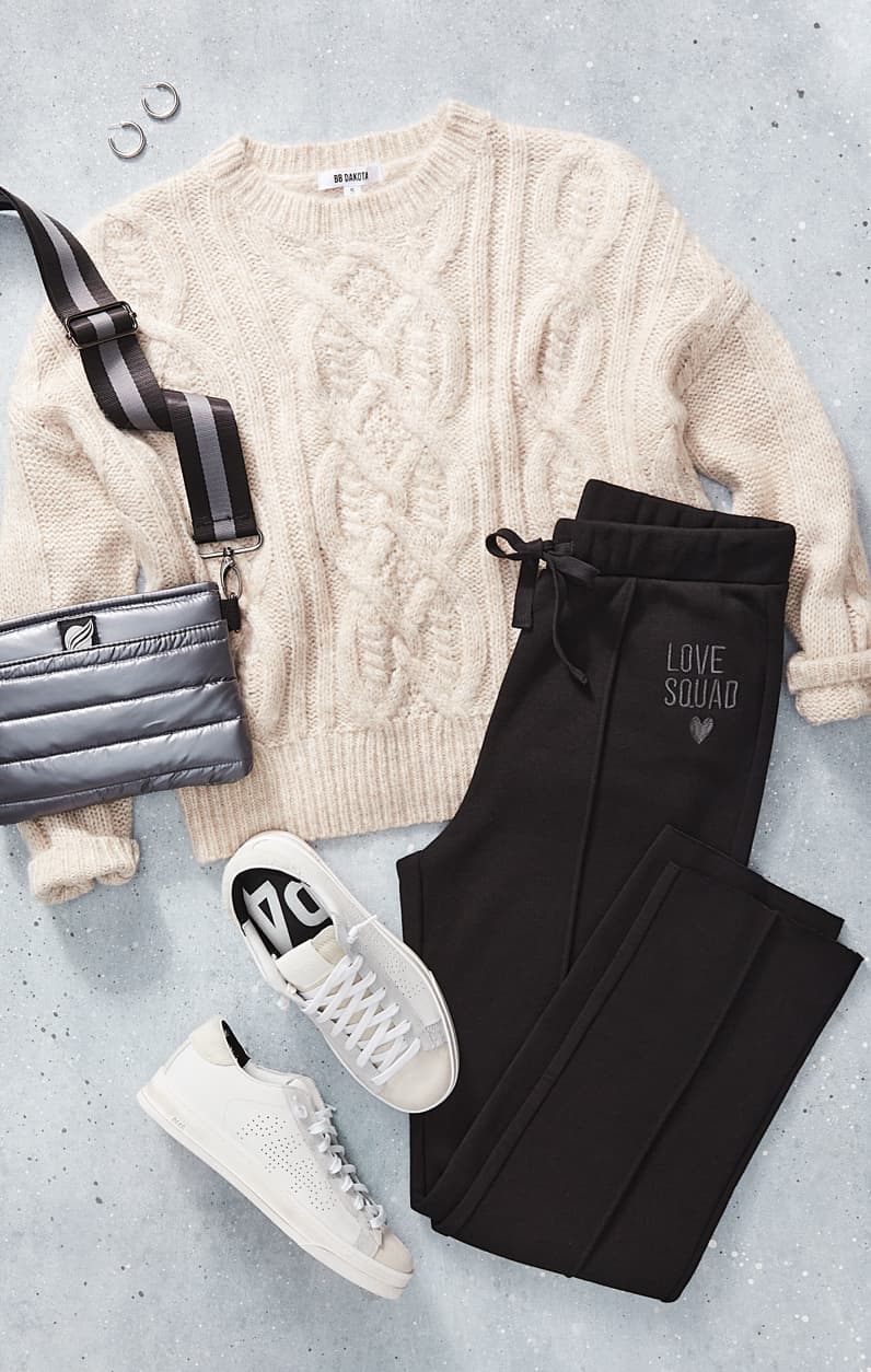 Lay down of sweater, sweatpants, a bag, and sneakers